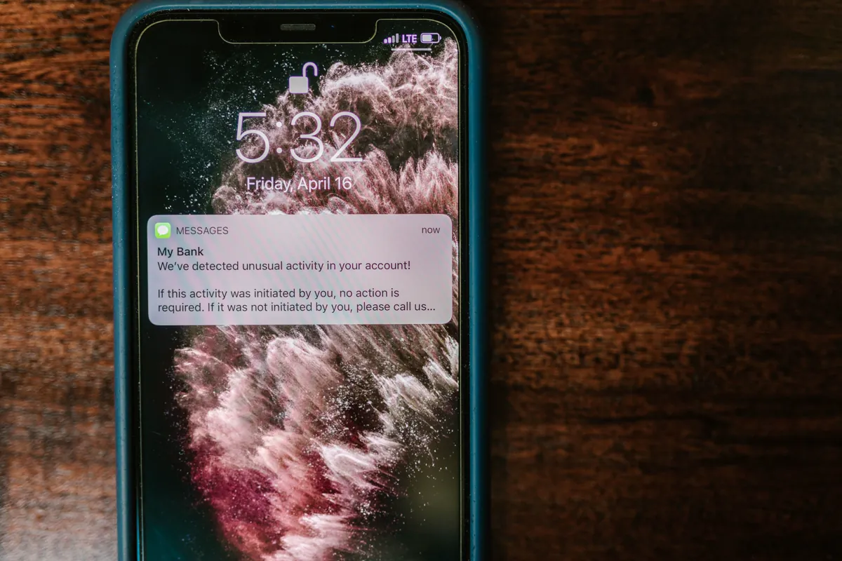 Fraud alert on a smartphone illustrating suspicious payment and phishing warnings