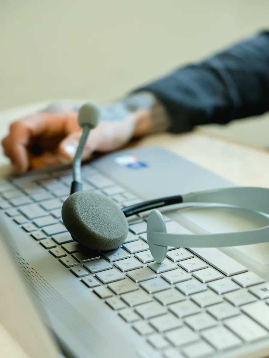 Laptop and headset illustrating support and complaint information routing